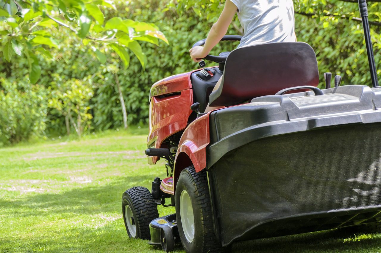 Person driving lawn tractor